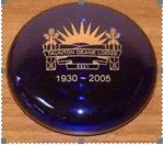 Blue glass paperweight with lodge emblem